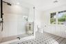 A frameless glass shower in the primary bath. Rinse off after a paddle from the Blue Point Dock, under half a mile away, then lunch at Flo's Luncheone