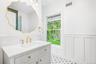 A sculpted gold mirror and white vanity bring jewel-box detail, made for an evening at the Blue Point Brewing tasting room on West Main Street in neig