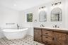 The primary bath: a freestanding soaking tub, patterned tile and a double vanity. Just as restorative, sunsets over the Great South Bay at the Blue Po