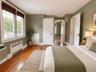 Hardwood flooring, multi-pane windows with integrated blinds, and solid-core interior doors with brass hardware