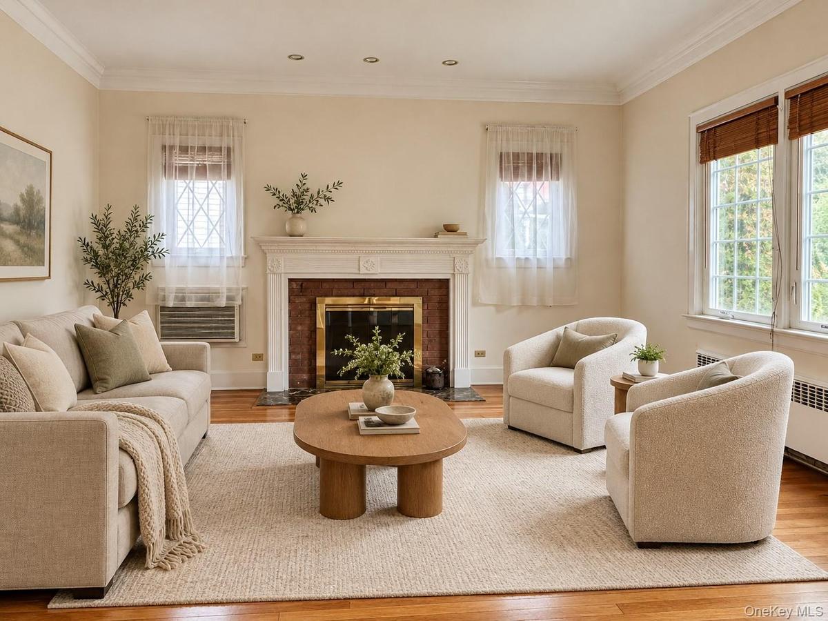 Living room featuring wood-finish flooring, a masonry fireplace with a classic mantel, recessed lighting, and crown molding