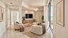 Living area featuring polished tile flooring, recessed ceiling lighting, a decorative pendant fixture, and expansive sliding glass doors ( AI used for
