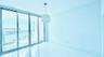 Floor-to-ceiling glass sliding doors, polished tile flooring, pendant lighting, and an expansive balcony