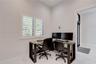 Neutral wall finishes, white plantation shutters, and large-format tile flooring