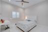 Neutral-toned bedroom featuring large-format tile flooring, recessed ceiling lighting, a contemporary ceiling fan, and plantation shutters