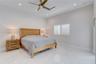High ceilings, polished stone-finish flooring, recessed lighting, ceiling fan, and plantation shutters