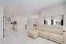 Open concept interior featuring high-gloss large-format tile flooring, stone-finish kitchen island, recessed lighting, and stainless steel built-in ap
