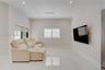 Polished stone-finish flooring, recessed lighting, wall-mounted television, and adjustable window shutters