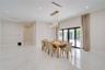 Open-concept space featuring polished stone-finish flooring, high ceilings with recessed lighting, multi-pendant spherical chandelier, and full-height