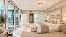 Floor-to-ceiling glass sliding doors, polished tile flooring, glass-enclosed shower, flush-mount crystal light fixture, and recessed lighting ( AI use