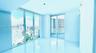 Floor-to-ceiling windows, white tile flooring, and sliding glass doors with direct exterior access