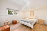 High-ceiling room featuring recessed lighting, wood-finish flooring, and a window with a roller shade