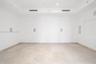 Tray ceiling with recessed lighting, stone flooring, and integrated wall-mounted speakers