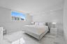 Polished stone flooring, recessed ceiling lighting, and a large window