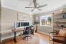 Room featuring wood-finish flooring, a matte finish ceiling fan with integrated lighting, and a single-pane window