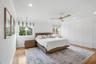 Interior space featuring wood-finish flooring, decorative wall paneling, crown molding, a central ceiling fan with wood-finish blades, and recessed li