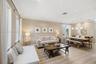 Open-concept interior featuring wood-finish flooring, recessed lighting, crown molding, and pendant lighting over the dining area