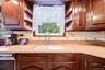 Large kitchen overlooks the pool with plenty of cabinets and easy flow to the adjacent dining room.