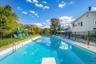 Diving board, paver surround and wrought iron fencing elevate this amazing pool experience.
