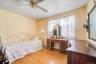 Third of 4 sunny bedrooms with hardwood floors.