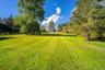 Lush lawns looking back up towards the side patio and home.