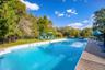 Lovely oversized inground pool with paver surround and sunny lounge area!