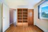 One of 4 large bedrooms with hardwood floors.