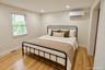 Wood-finish flooring, recessed lighting, mini split, and double-pane window with horizontal blinds
