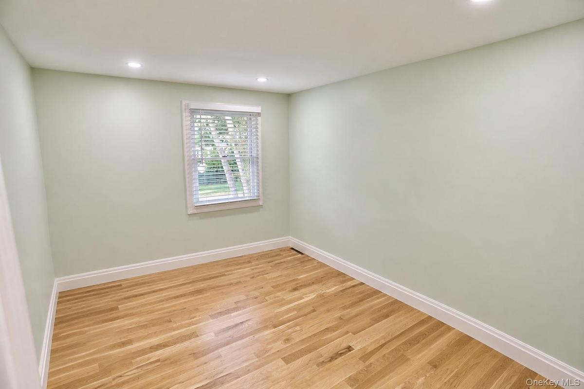 Room featuring wood-finish flooring, recessed lighting