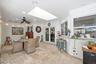 Covered patio featuring stone-tile flooring, a large skylight, recessed lighting, and a built-in stone-surfaced breakfast bar
