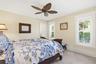 Interior room featuring tile flooring, white interior window shutters, and a leaf-inspired ceiling fan