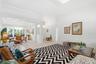 Open-concept interior featuring oversized tile flooring, crown molding, structural columns, and recessed lighting