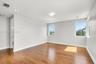 Interior space featuring wood-finish flooring, recessed ceiling lighting, and multiple windows