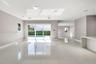 Open floor plan featuring oversized polished porcelain tile flooring, recessed lighting, and a waterfall-edge kitchen island