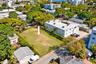 Vacant residential lot featuring perimeter landscaping and mature trees