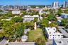 Vacant rectangular lot featuring level topography, perimeter fencing, and mature canopy trees