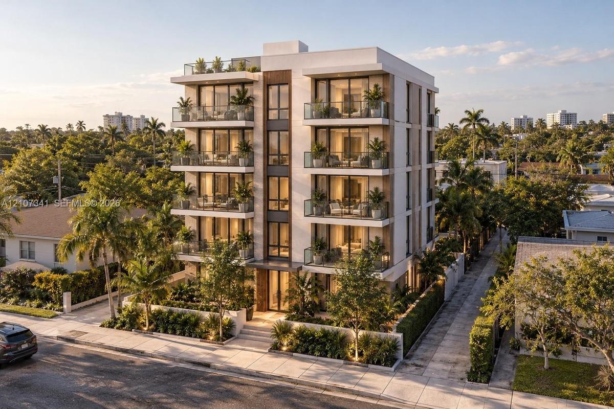Multi-story residential building featuring a modern stucco facade, glass-panel balconies, full-height window walls, and landscaped ground-level hardsc