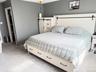 Plush carpeting, recessed walk-in closet, and neutral wall tones