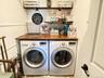 Front-loading washer and dryer units with a wood-finish countertop