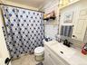White vanity with integrated sink and speckled countertop