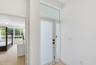 Entryway featuring a glass-panel door with frosted finish, transom window, and wood-finish flooring