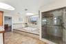 Bathroom featuring vanity and plus walk in shower