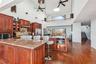 Kitchen featuring sink, a breakfast bar area, ceiling fan, stainless steel appliances, and decorative backsplash