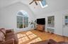 Vaulted ceiling with oversized Palladian windows that overlooks the yard