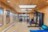 Workout area with hardwood / wood-style flooring, wooden walls, a skylight, and wooden ceiling