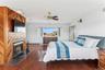 Bedroom featuring dark hardwood / wood-style floors and ceiling fan