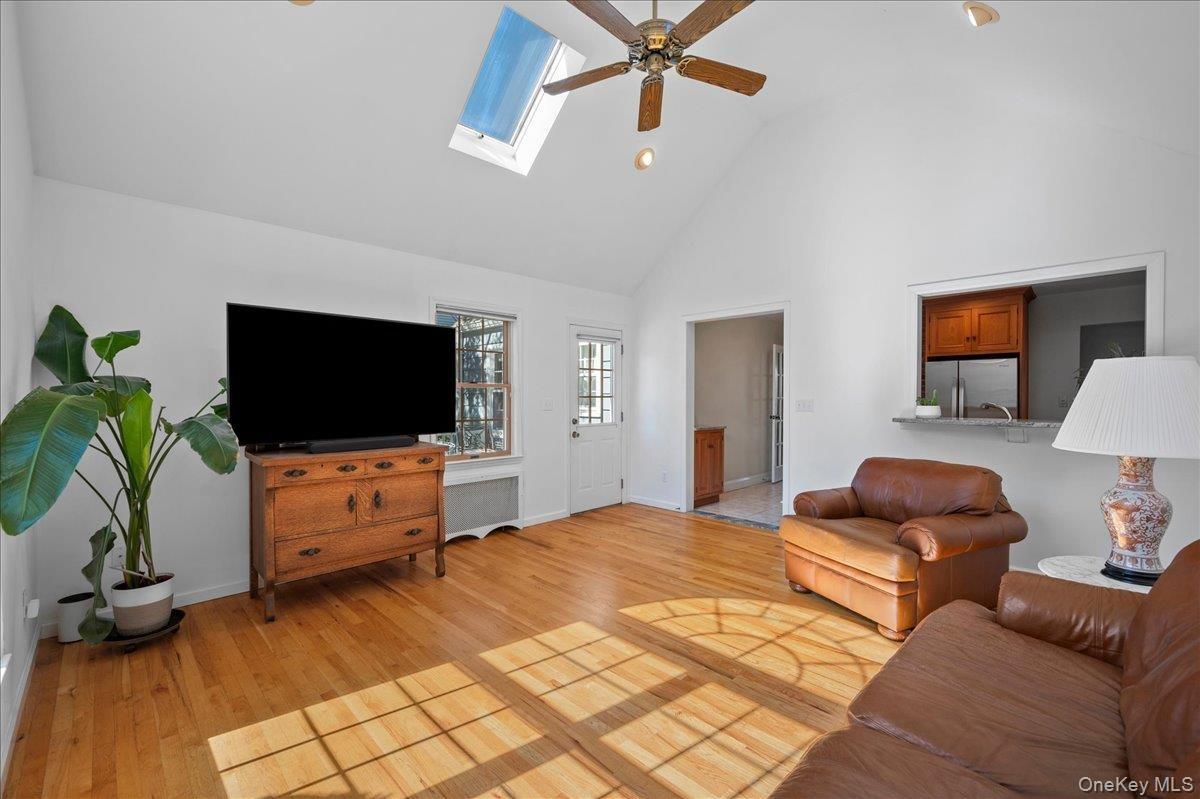Great room with a view of the breakfast bar area, skylights and door to the deck