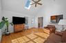 Great room with a view of the breakfast bar area, skylights and door to the deck