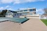 Rear view of house with a pool side deck and a patio area