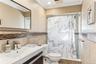 Bathroom featuring vanity, crown molding, toilet, and walk in shower